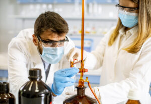 group of young researchers analyzing chemical data in the labora